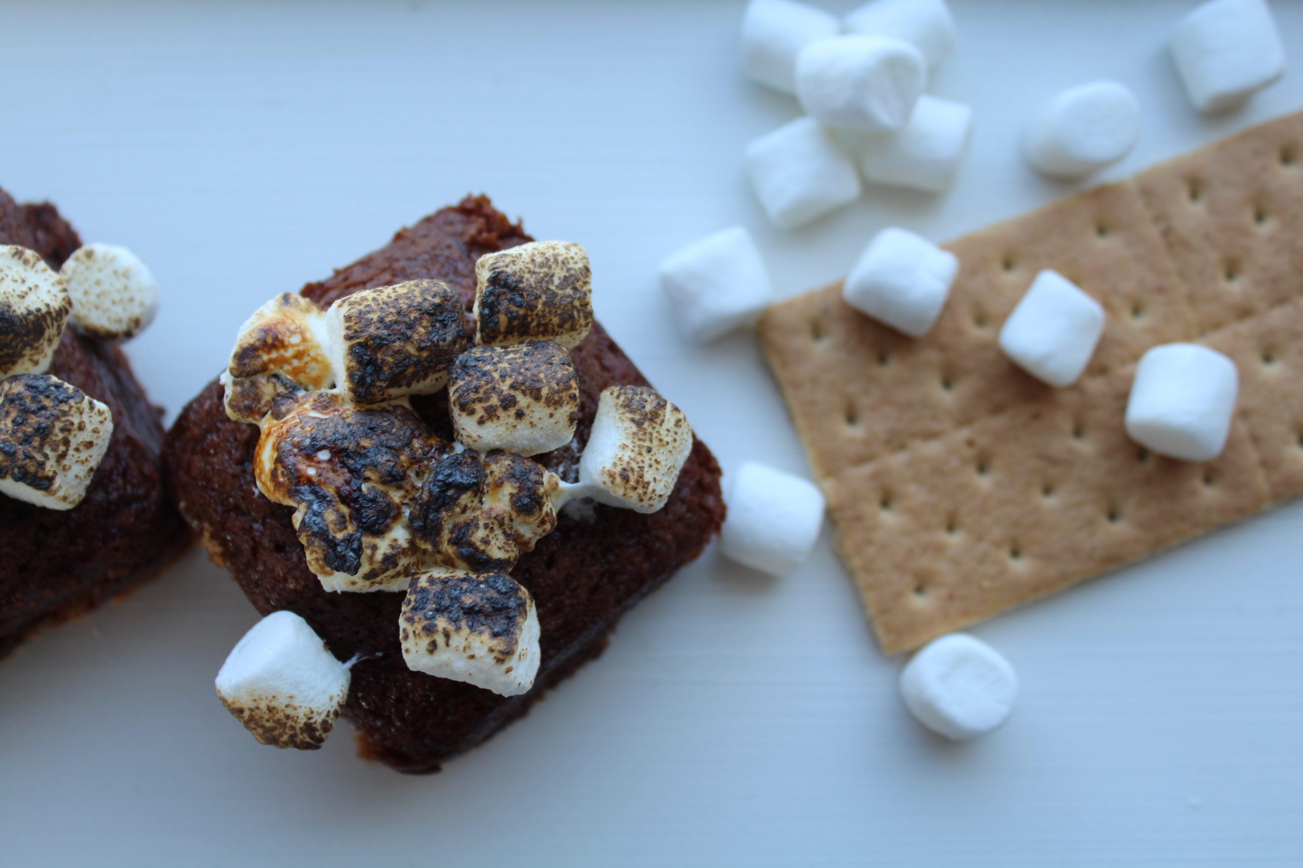 s'more brownies with a graham cracker and marshmallows